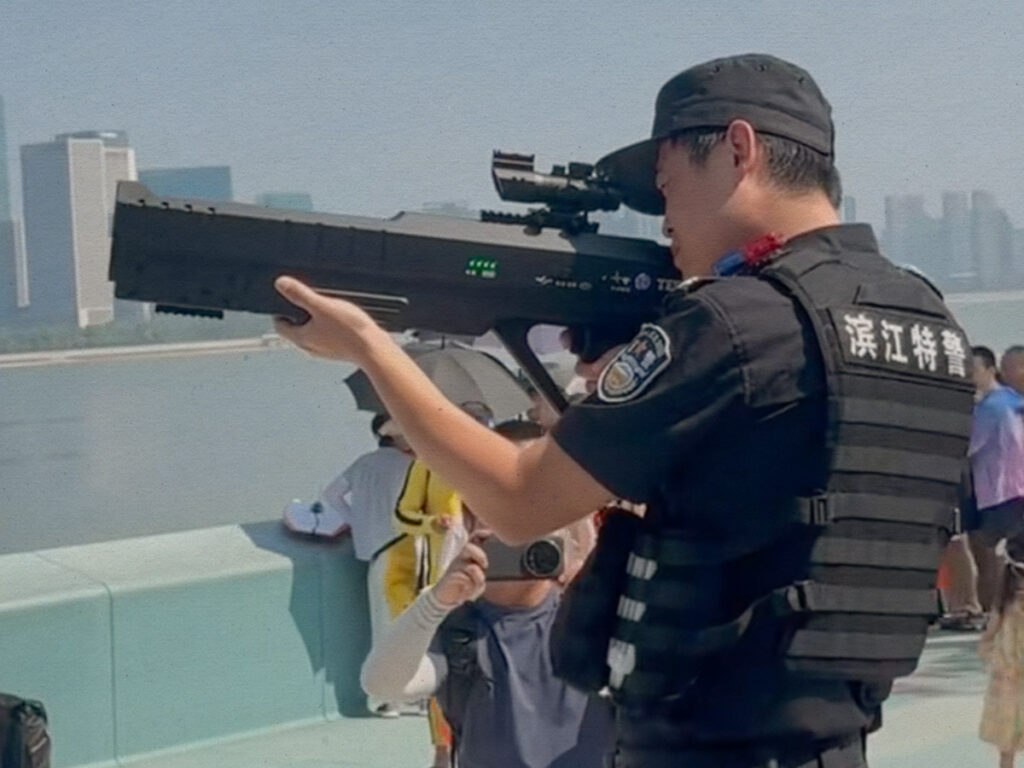 A still from a TikTok video depicting a Chinese police officer with an anti-drone gun.